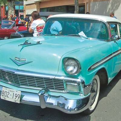 a man admires a turquoise classic car during the annual Qualicum Beach Fathers Day Seaside Cruizers Show & Shine.