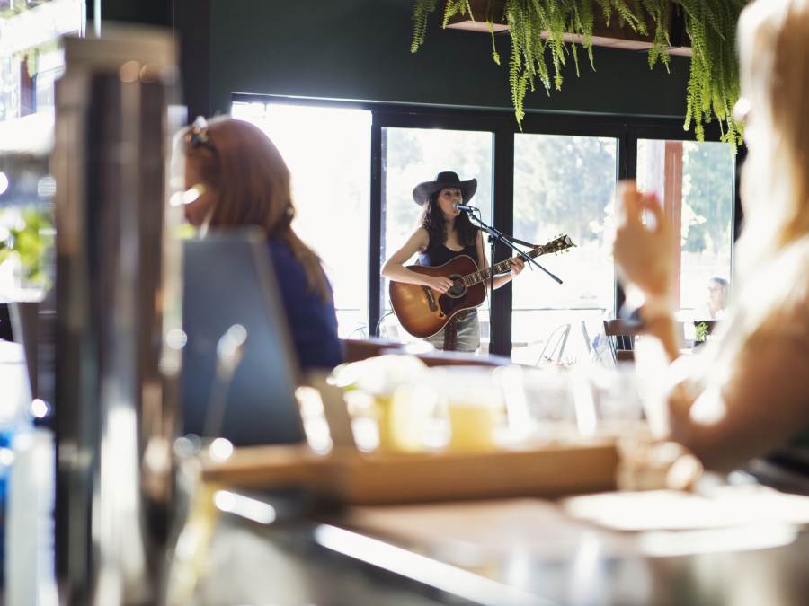 Performer providing live music at a restaurant in Parksville Qualicum Beach, Vancouver Island.