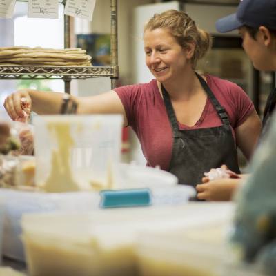 artisans have fun while crafting pizzas in the kitchen at Wild Culture Bakery