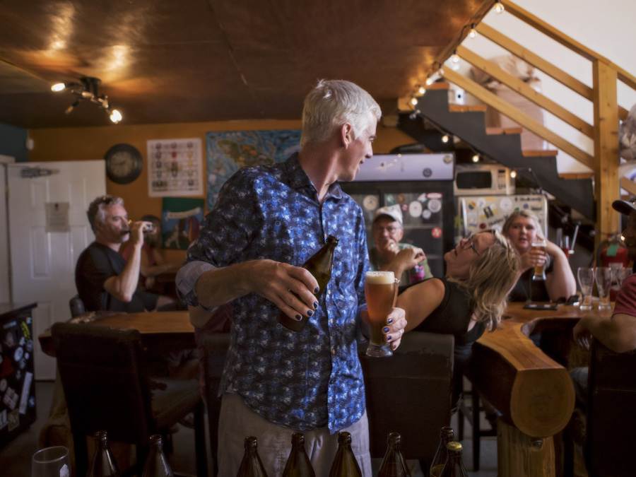 Dave, owner of LoveShack Libations, talking to patrons while preparing a beverage