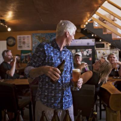 Dave, owner of LoveShack Libations, talking to patrons while preparing a beverage