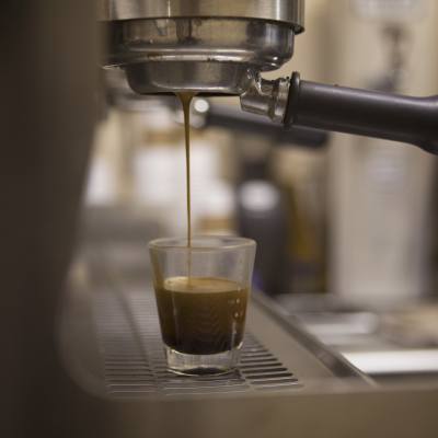 A shot of espresso being poured in a cafe in Parksville Qualicum Beach, Vancouver Island.