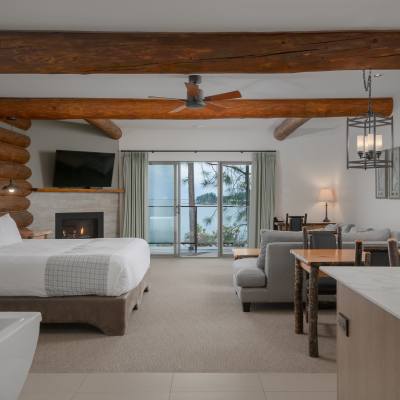 room with a couch, fireplace and bed at Tigh-Na-Mara Seaside Spa Resort overlooking the sea in Parksville Qualicum Beach