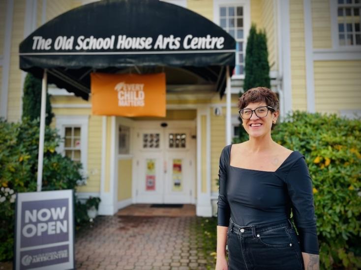 Illana Hester standing in front of The Old School House Arts Centre in Qualicum Beach.