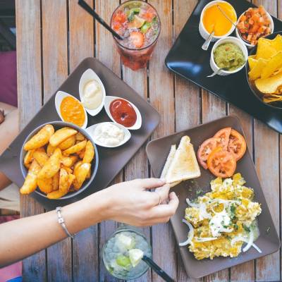 A woman enjoying restaurant food and salads in Parksville Qualicum Beach on Vancouver Island.