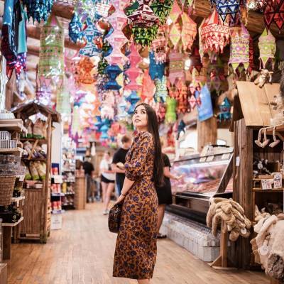 A woman admires hanging lanterns in Coombs Old Country Market while shopping