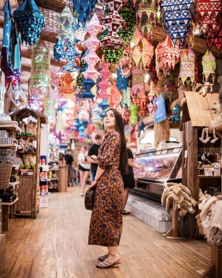 A woman admires hanging lanterns in Coombs Old Country Market while shopping