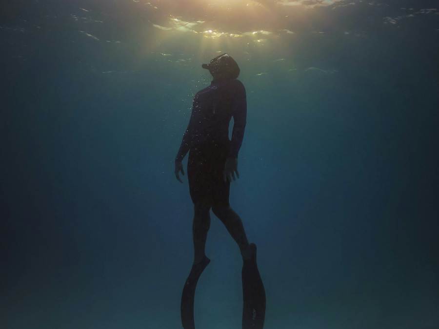 scuba diver ascending to top of water in Parksville Qualicum Beach BC Canada