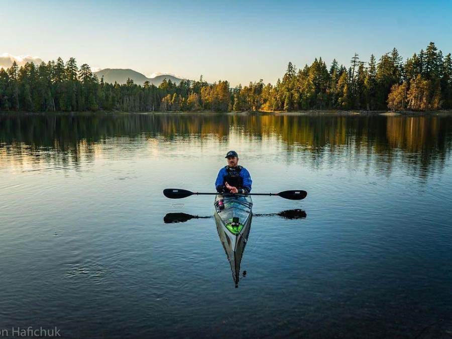 Person in kayak Paddling Calm Waters on lake in Parksville Qualicum Beach BC Canada