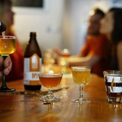four unique glasses filled with different craft beers on a bar at a Parksville Qualicum Beach brewery