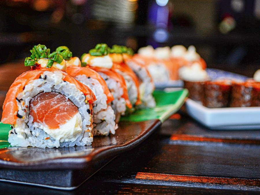 Salmon and cream cheese rolls sit on a multi-colored plate at a restaurant in Parksville Qualicum Beach.