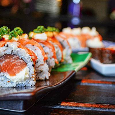 Salmon and cream cheese rolls sit on a multi-colored plate at a restaurant in Parksville Qualicum Beach.