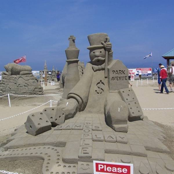 a sand sculpture of the Monopoly mascot at QF Canadian Open Sand Sculpting Competition and Exhibition