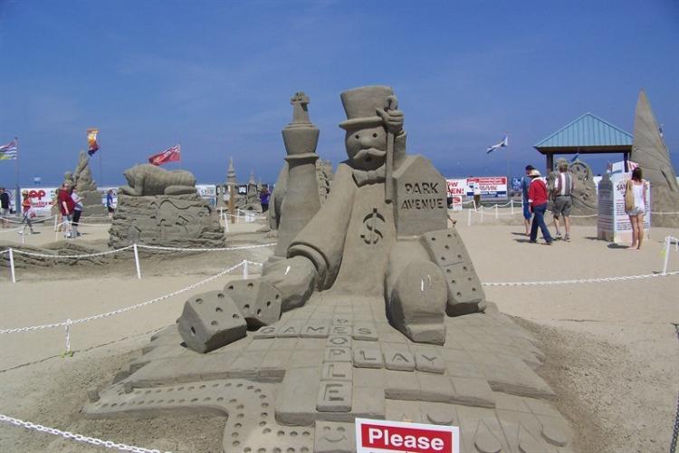 a sand sculpture of the Monopoly mascot at QF Canadian Open Sand Sculpting Competition and Exhibition